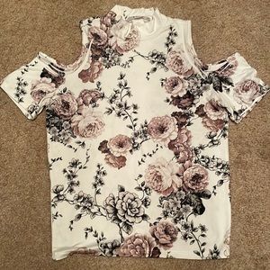 Tight fit floral  blouse with shoulder cutouts.